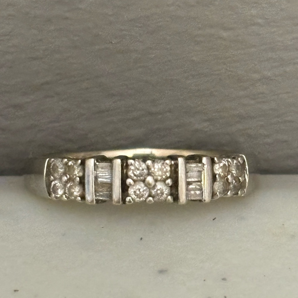 14k gold white  JWBR wedding band with diamonds unknown weight and carats.